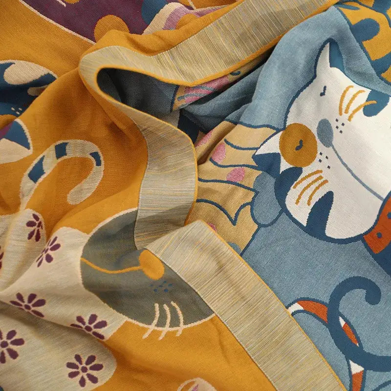 A soft pure cotton gauze towel blanket with cat cartoon animal embroidery in vibrant yellow and blue for bedroom decorbites decor