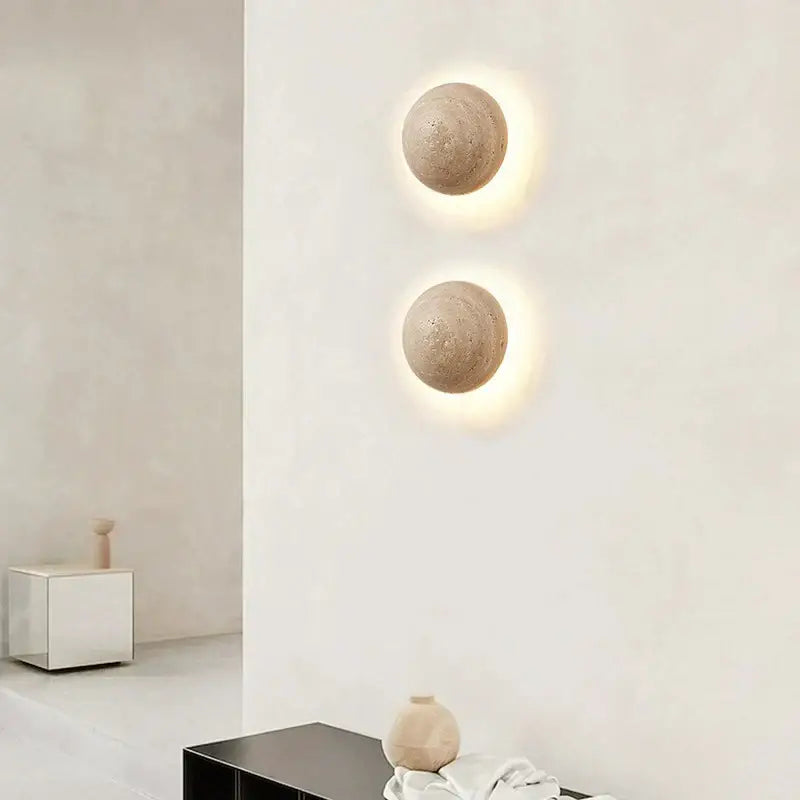 Two beige cave stone yellow textured sphere wall lamps by decorbites with warm light for bedroom ambiance wall lamp decor
