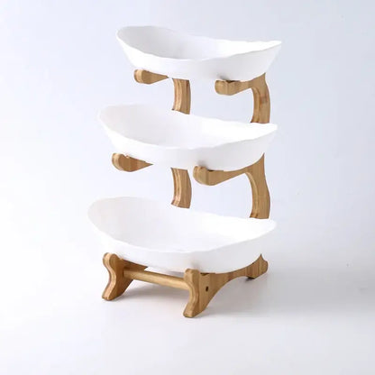 Three-tiered white ceramic table plates set with light wood bamboo frame for dining room and kitchen use
