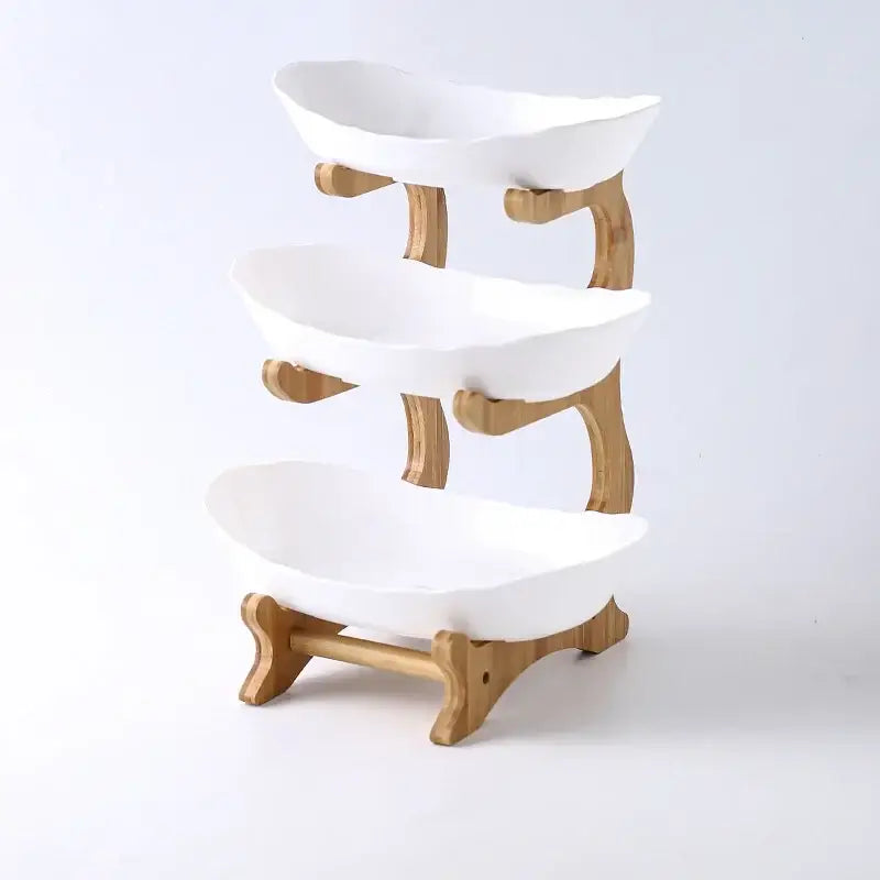 Three-tiered white ceramic table plates set with light wood bamboo frame for dining room and kitchen use