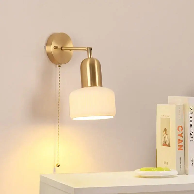 Gold-toned ceramic art wall lamp with frosted glass shade and adjustable arm for bedroom reading light
