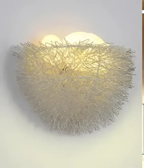 Silver-toned led wall lamp with a woven wireframe nest design featuring ceramic bird for bedroom decor