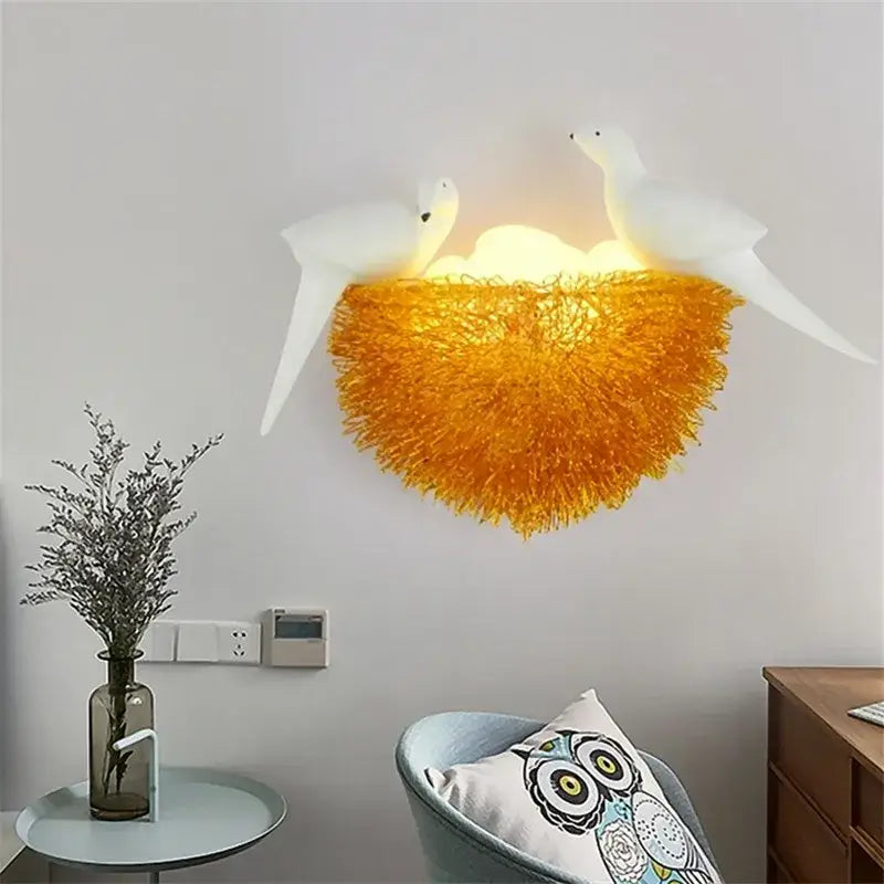 Ceramic white bird led wall lamp with glowing orange textured golden nest base for bedroom sconce lighting