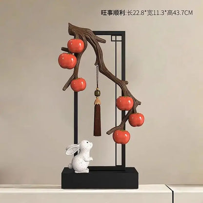 Ceramic home decor set featuring dark brown branch with glossy red persimmons and white rabbit for living room