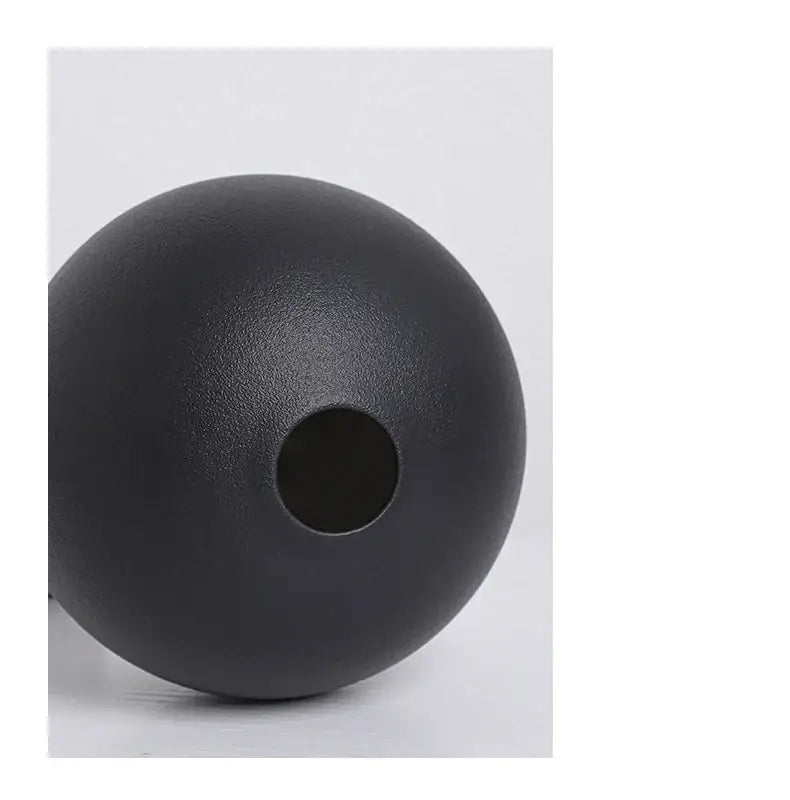 Black matte ceramic round vase black white with central hole showcasing minimalist modern design