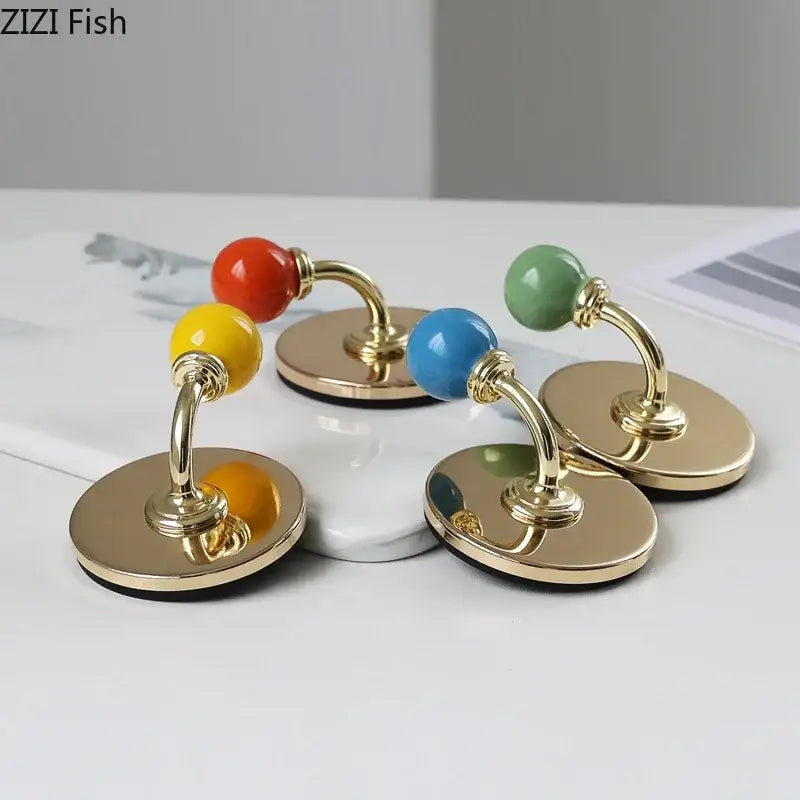 Colorful ceramic ball wall hooks with gold-tone bases for storage organizer in bedroom decorbites colorful wall design