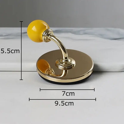 Gold-toned ceramic wall hook with glossy yellow spherical handle and circular base for decorbites colorful wall storage organizer