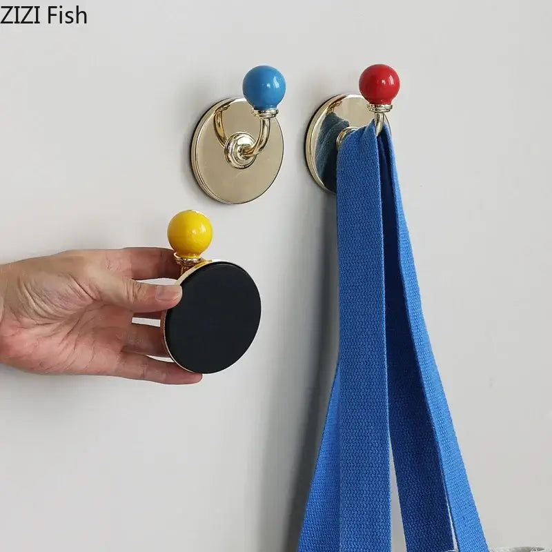 Gold-toned wall hooks with colorful blue red and yellow ceramic ball tops for decorbites colorful wall storage organizer