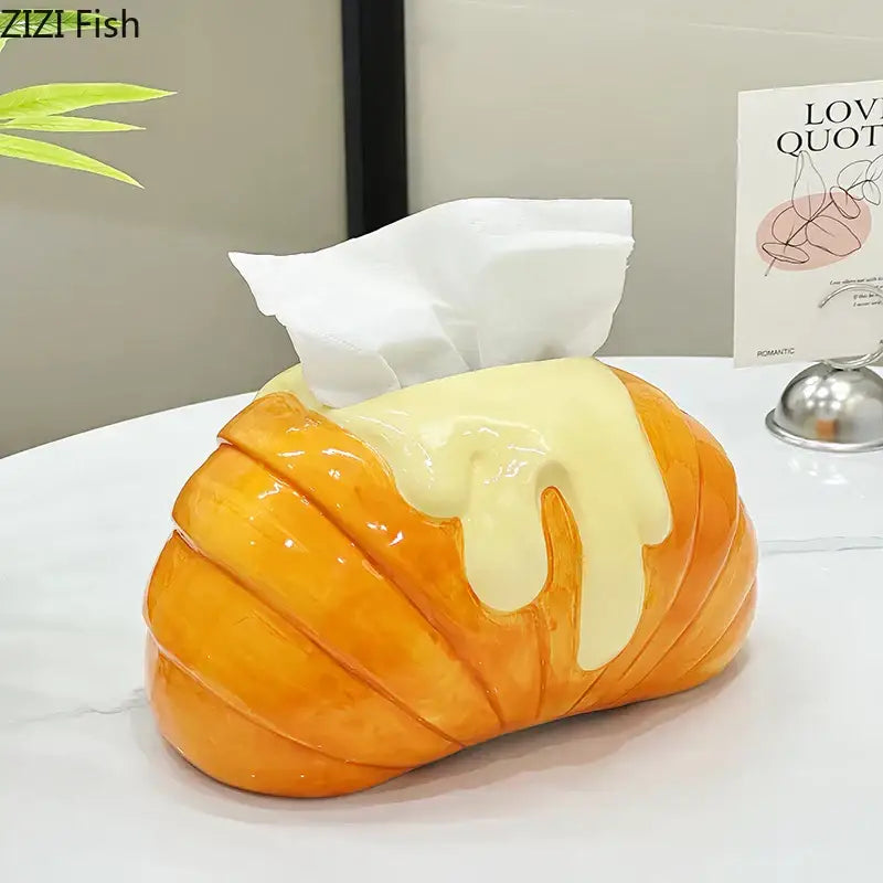 Charming orange and yellow croissant ceramic tissue box with yellow icing drizzle for bedroom decor by decorbites