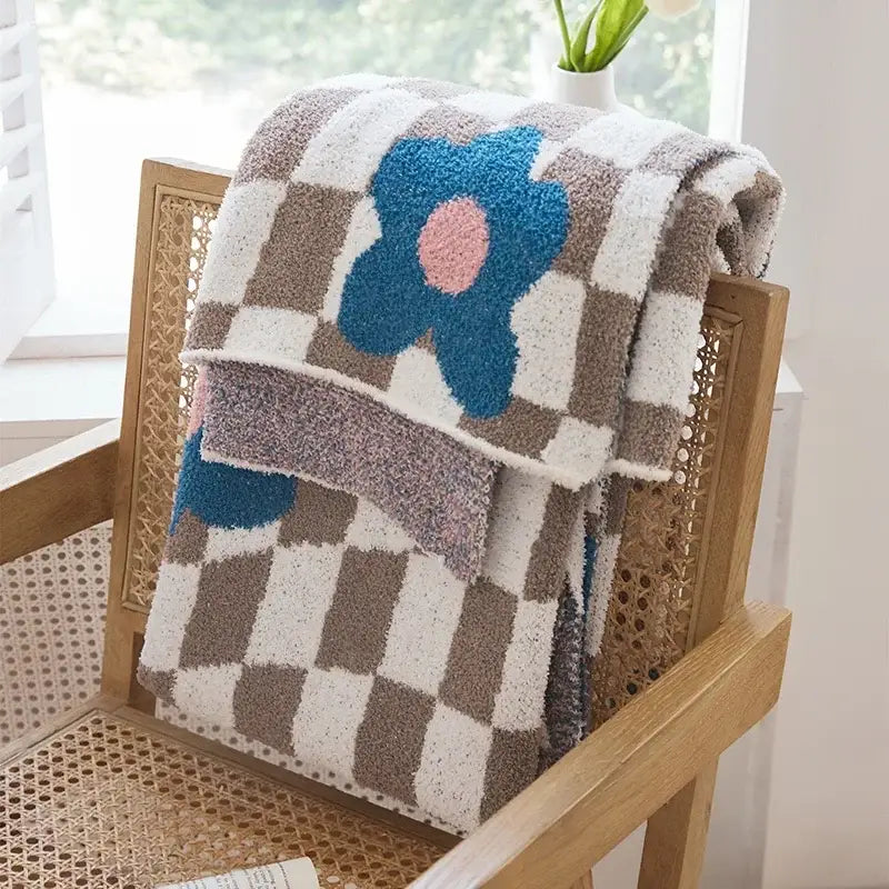 A beige and brown checkered decorbites knitted blanket throws 130x160cm with a blue flower detail for bedroom decor