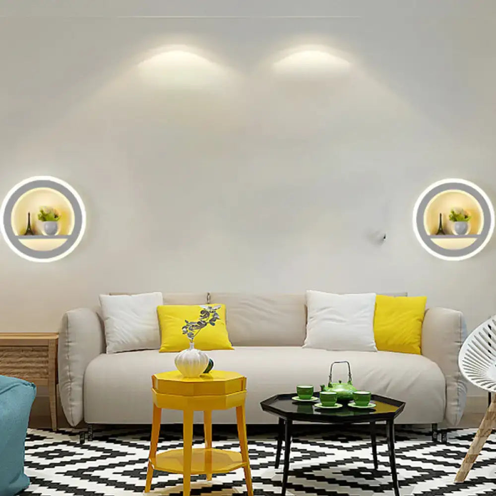 Beige sofa with white and yellow throw pillows near cheerful white smiling sun led wall sconce bedroom light