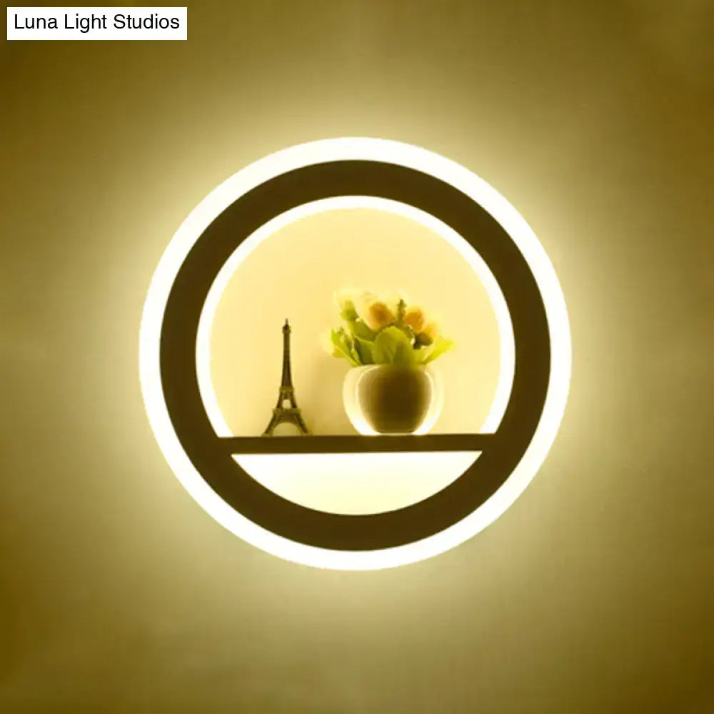Cheerful white smiling sun led wall sconce with glowing circular white ring illuminating eiffel tower model and yellow flowers