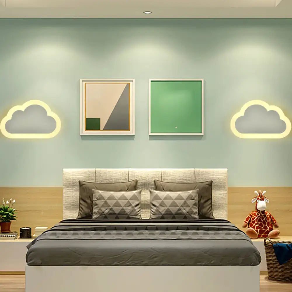 A cheerful white smiling sun led wall sconce bedroom light above a cozy bed with a beige headboard and gray geometric bedding