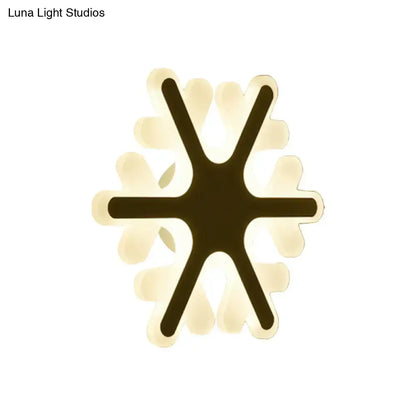 Modern star-shaped cheerful white smiling sun led wall sconce with black frame and glowing translucent white petals for bedroom lighting