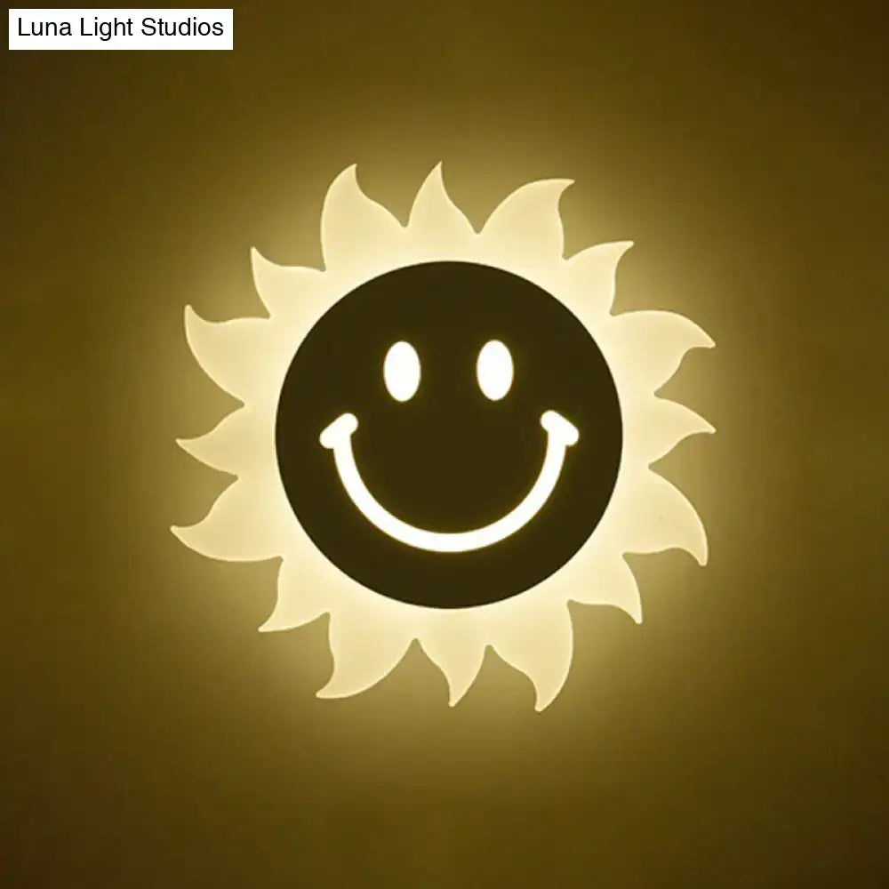 Cheerful white smiling sun led wall sconce featuring a warm glowing sun shape with black face and radiant white rays