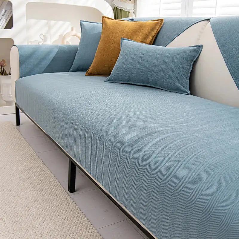 Light blue chenille textured non-slip sofa cover with matching cushions and mustard yellow accent pillow for living room sofa cushion