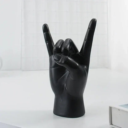 Chic black glossy resin hand gesture sculpture making a rock gesture for living room decor