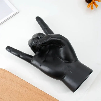 Chic black glossy resin hand gesture sculpture making a rock gesture for living room decor