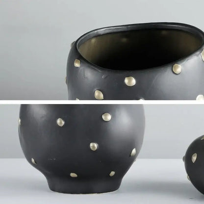 Chic black resin flower pot with gold accent featuring a black ceramic vase adorned with scattered gold-toned studs