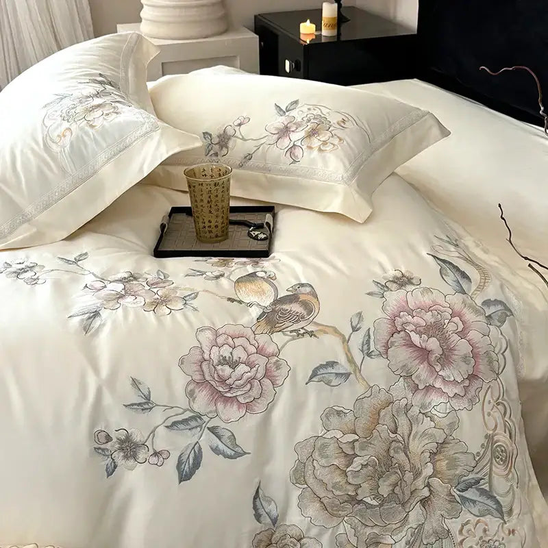 Cream-colored satin duvet cover with chinese flowers bird embroidery featuring pink peonies and green leaves bedding set