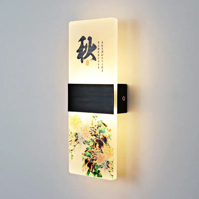 A modern wall lamp with an off-white acrylic shade featuring black chinese character autumn and floral decorbites acrylic shade