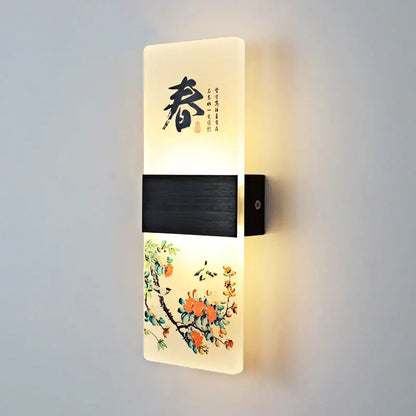 This modern wall lamp features an illuminated translucent white acrylic shade with Chinese calligraphy and floral art
