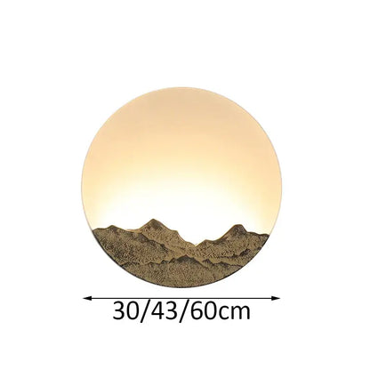Circular wall light with warm glow and embossed chinese mountain silhouette in bronze and gold decorbites led wall light