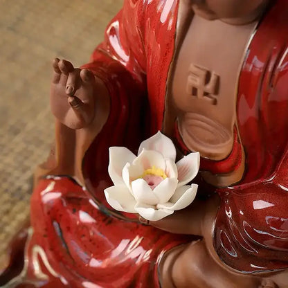 Glossy red ceramic sakyamuni buddha statue holding white lotus flower for living room bronze and silver style decor