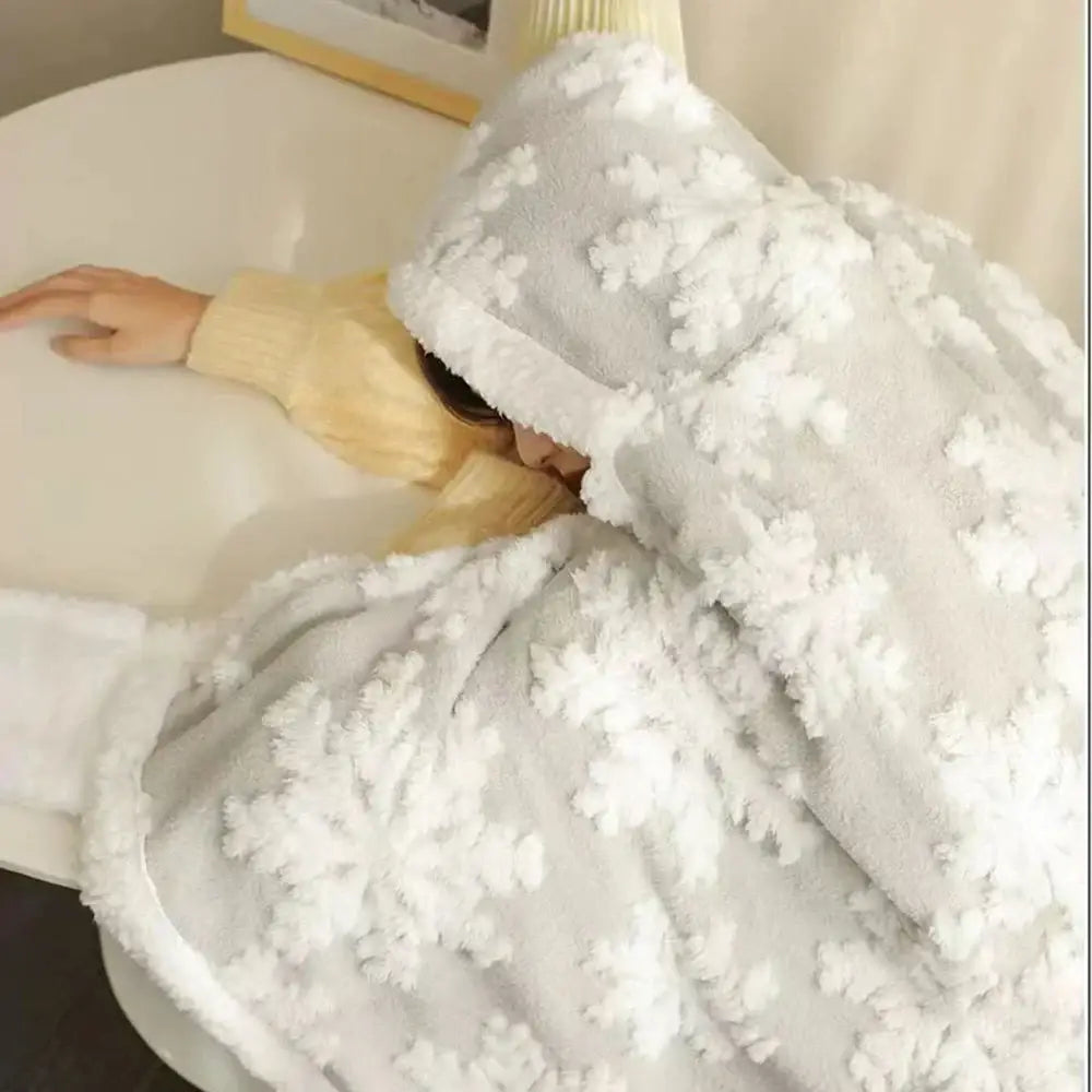 A cozy light gray wearable blanket with plush white snowflake appliqués in coral velvet by decorbites hooded christmas