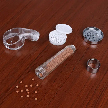 Clear plastic shower filter cartridge with tan and white ceramic beads for chrome anion spa shower head decorbites anion spa