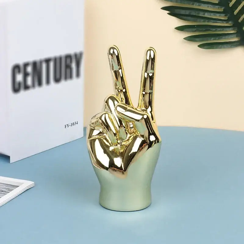 Golden ceramic hand love gesture figurine sculpture with glossy finish ideal for living room decor