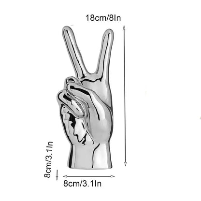 Shiny silver chrome ceramic love gesture figurine sculpture of a hand making the peace sign for living room decor