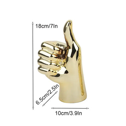 Golden metallic love gesture figurine sculpture with polished reflective surface and upward thumb for living room decor