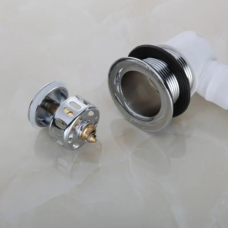 Chrome finished copper foot push bathtub drain pipe showing brass internal mechanism and black gasket for decorbites copper tub