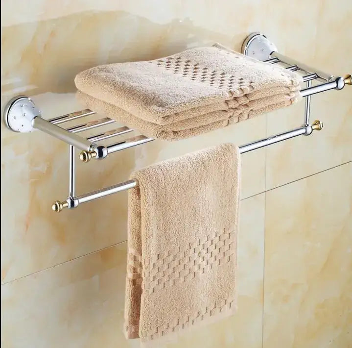Beige towel rack with polished chrome finish and gold-toned caps in a chrome and gold decorbites bathroom hardware set