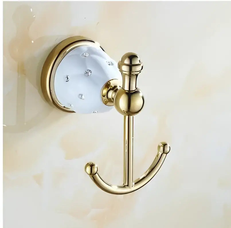 Gold-toned bathroom hook with white crystal accent and polished metal finish from decorbites bathroom hardware set