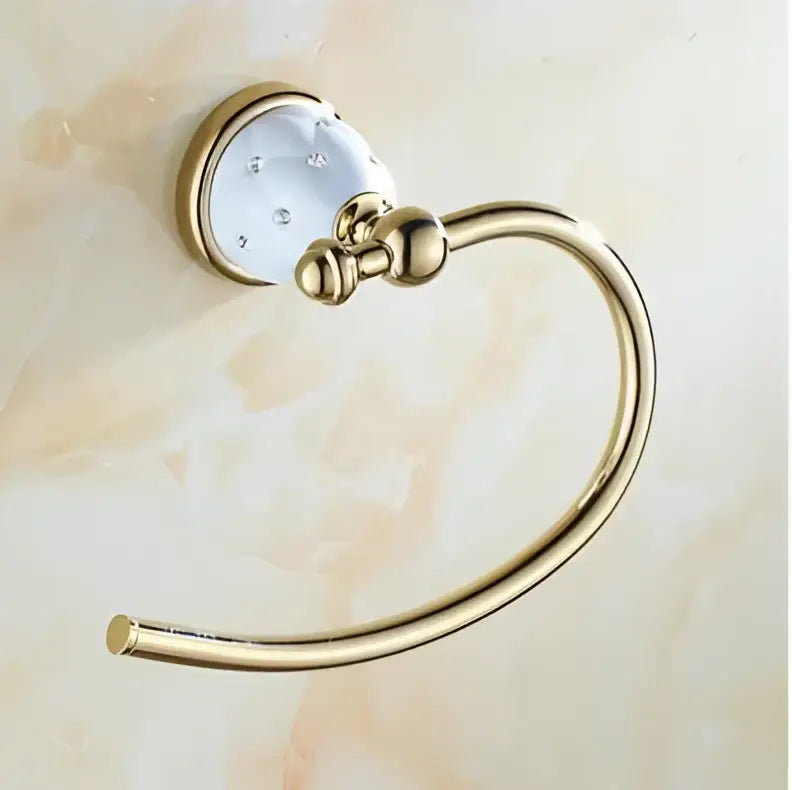 Gold-toned towel ring with decorative white ceramic head and clear crystals from decorbites bathroom hardware set