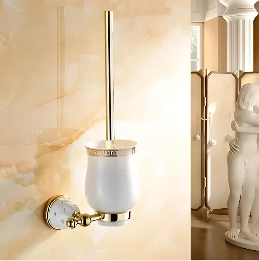 White ceramic toilet brush holder with gold-toned accents and greek key pattern mounted wall for bathroom hardware set
