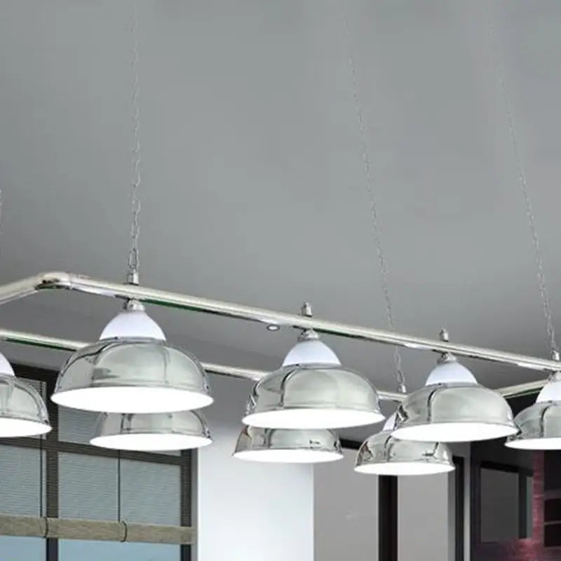 Chrome finished stainless steel billiard pendant lights with white diffusers hanging from a metal rod for game room ceiling