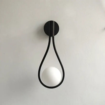 Black metal teardrop wall sconce with white glass ball for bedroom featuring decorbites black glass design