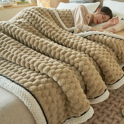 Beige plush coral fleece blanket with textured pom-pom pattern and contrasting white knitted trim for bedroom throw
