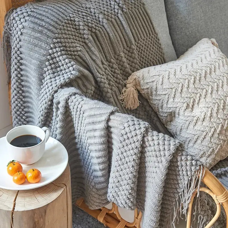 Gray cozy knitted sofa blanket with chunky ribbed texture and tassel accent for living room decorbites comfort