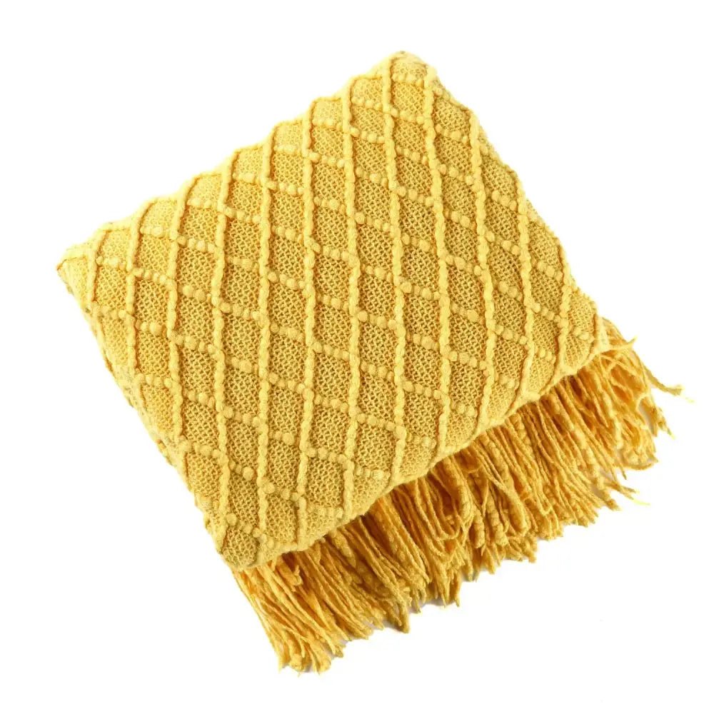 Cozy knitted sofa blanket in mustard yellow with diamond texture and fringed edges for living room comfort decorbites cozy knitted