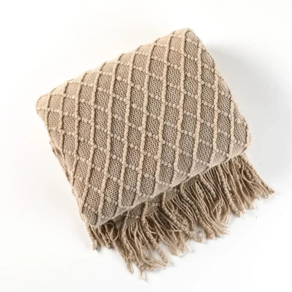 Beige chunky ribbed knitted sofa blanket with diamond pattern and tassels for decorbites cozy knitted living room comfort