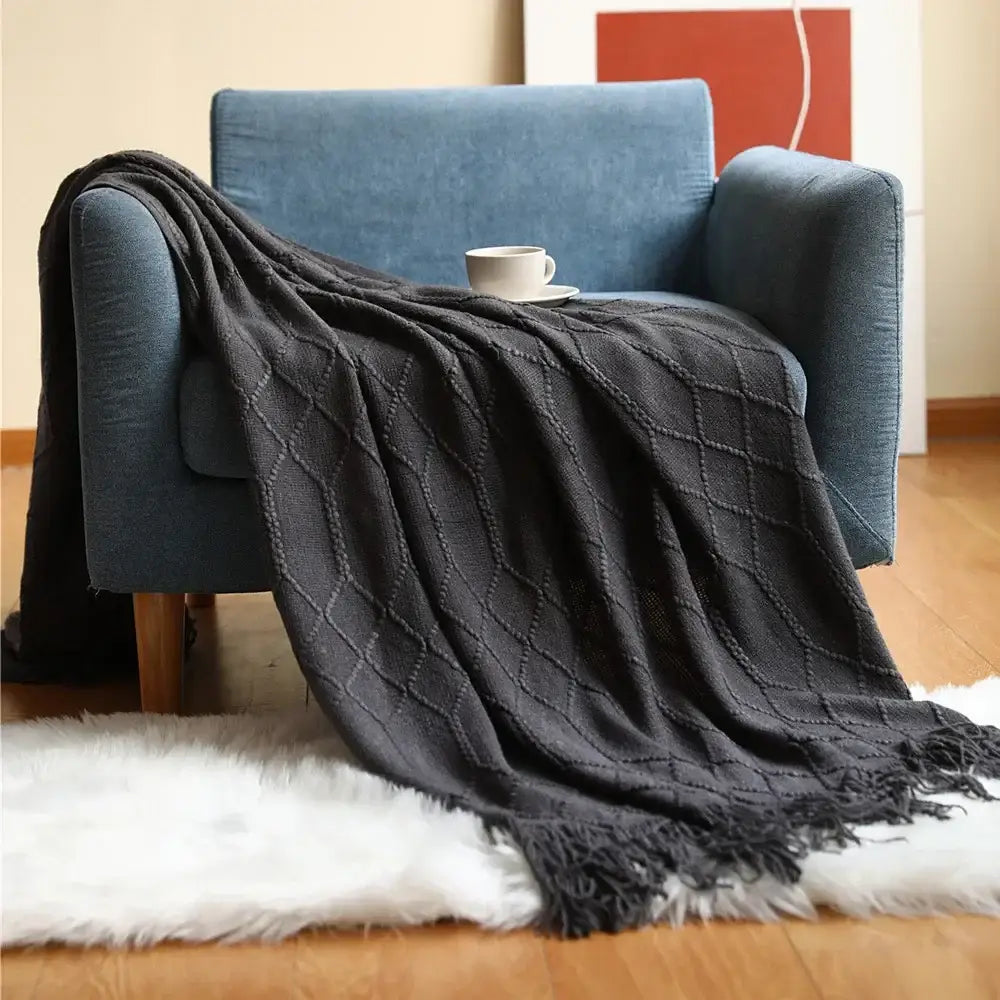 Dark gray chunky ribbed knitted sofa blanket with diamond pattern and fringed edges for decorbites cozy knitted decor