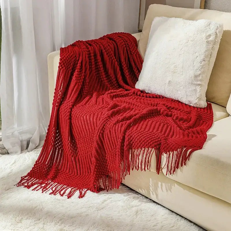 Vibrant red cozy knitted sofa blanket with textured cable pattern and fringe trim for decorbites cozy knitted decor