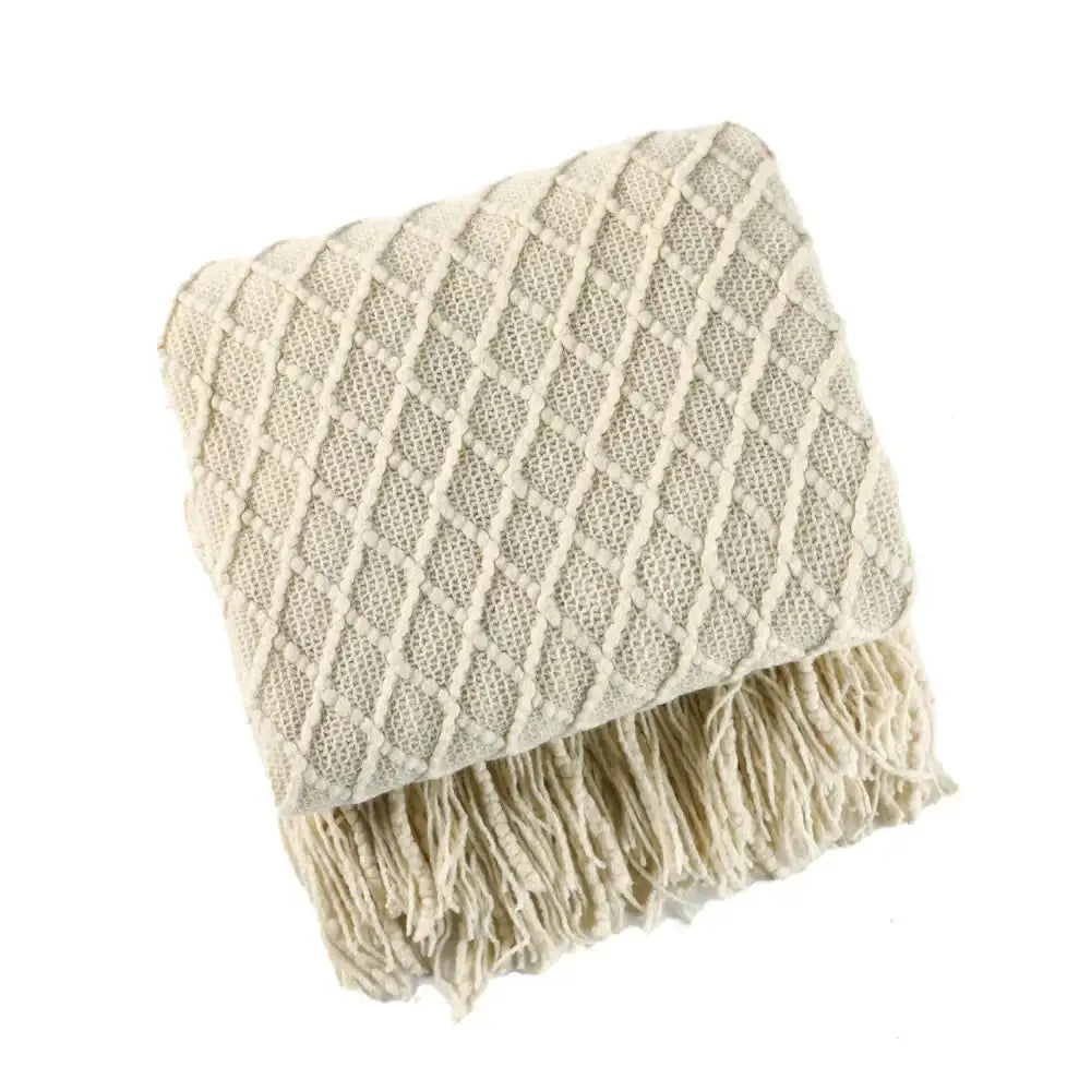 Cream-colored cozy knitted sofa blanket with diamond pattern and fringe for living room decorbites cozy knitted comfort