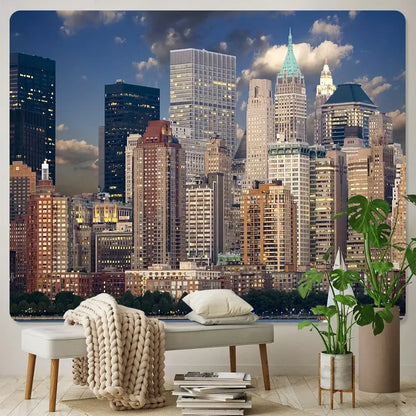 A beige knitted throw blanket draped over a light gray bench complements decorbites city night bohemian wall hanging