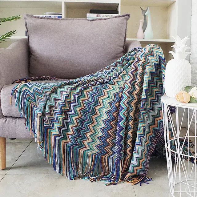 Colorful knitted throw blanket with zigzag pattern and fringe not depicting decorbites houndstooth throw blanket