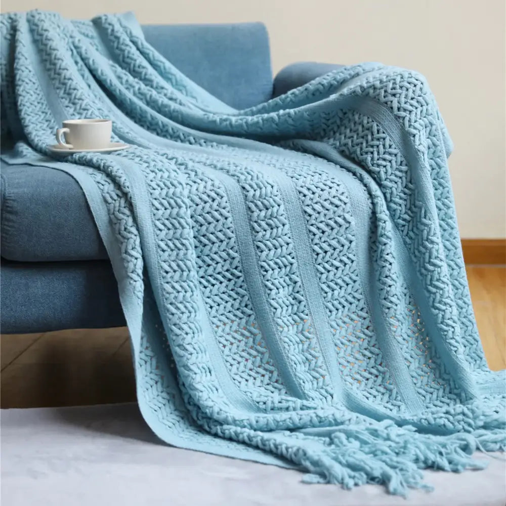 A soft light blue knitted throw blanket with textured herringbone pattern and fringed edges for cozy decorbites houndstooth throw